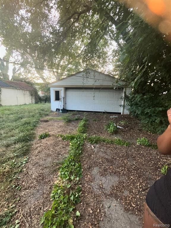 exterior space with a garage and an outdoor structure