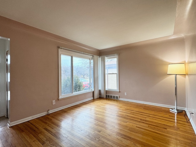 spare room featuring light hardwood / wood-style floors