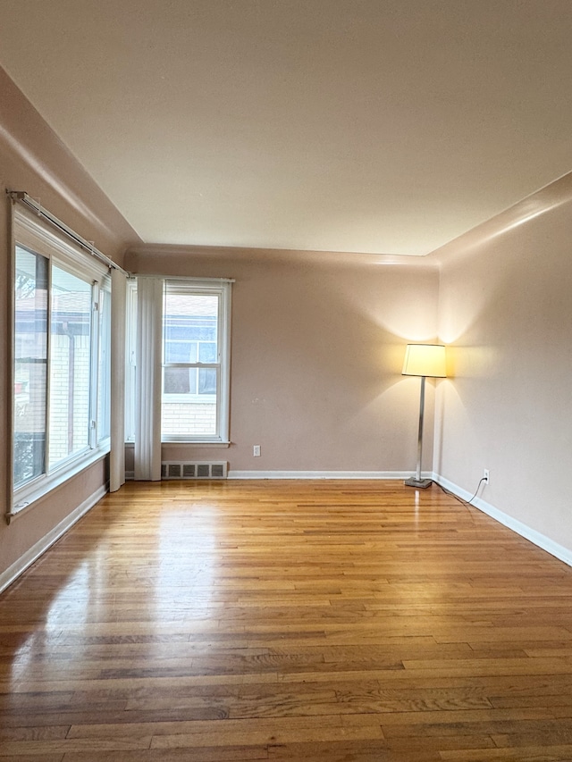 unfurnished room featuring hardwood / wood-style flooring