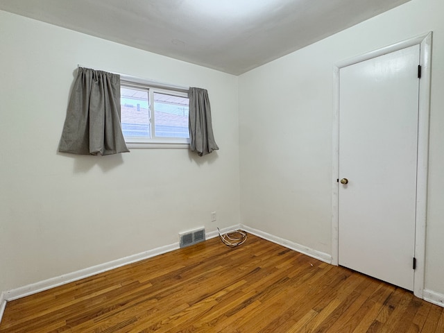 unfurnished room featuring hardwood / wood-style floors