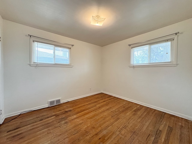 spare room with wood-type flooring