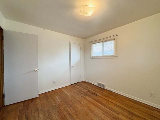 unfurnished room featuring hardwood / wood-style flooring