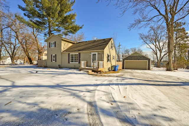 rear view of house with a garage and an outdoor structure