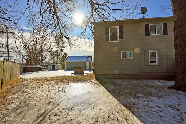 view of side of home with a shed