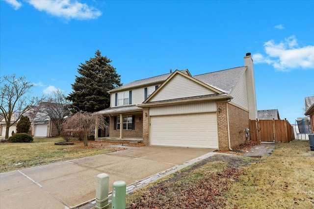 view of front property featuring a garage and a front lawn