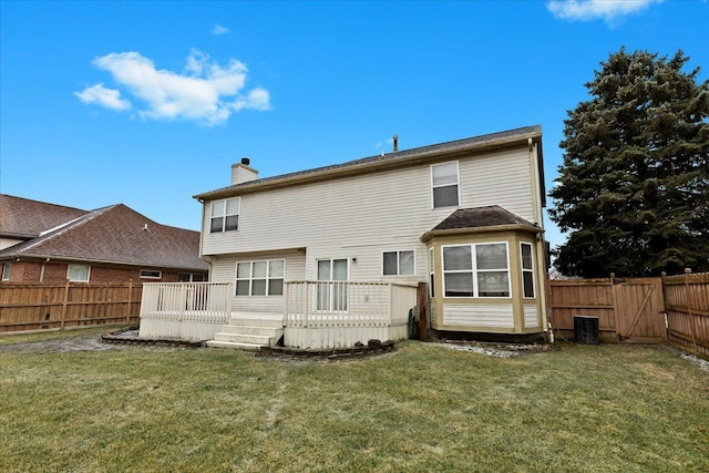 back of house with a wooden deck and a yard