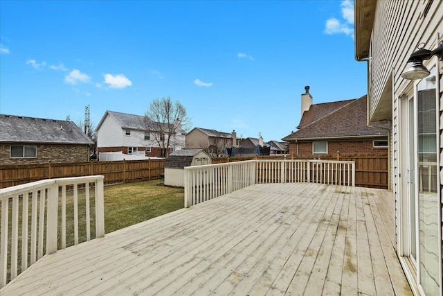 deck with a lawn and a storage unit