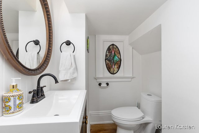 bathroom featuring vanity and toilet