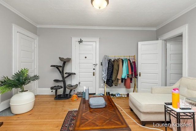 interior space featuring wood-type flooring and ornamental molding