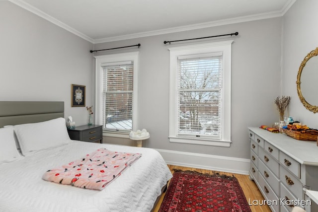 bedroom featuring crown molding and light hardwood / wood-style floors