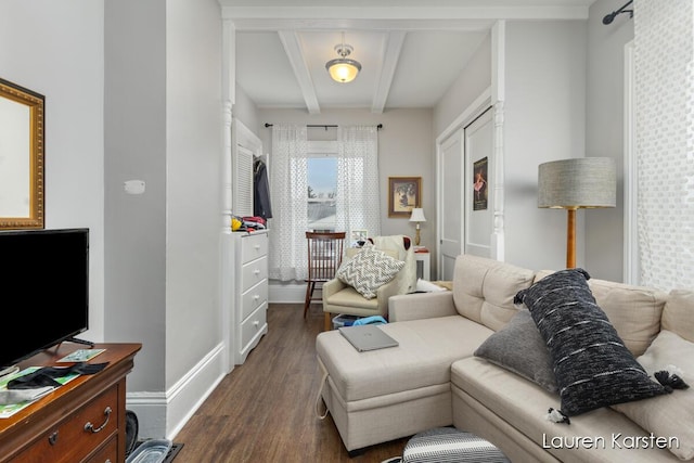 living room with dark hardwood / wood-style floors and beamed ceiling