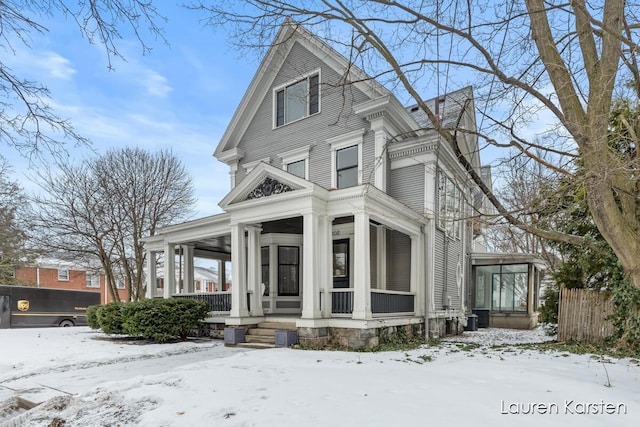 view of front of house with central AC unit and a porch