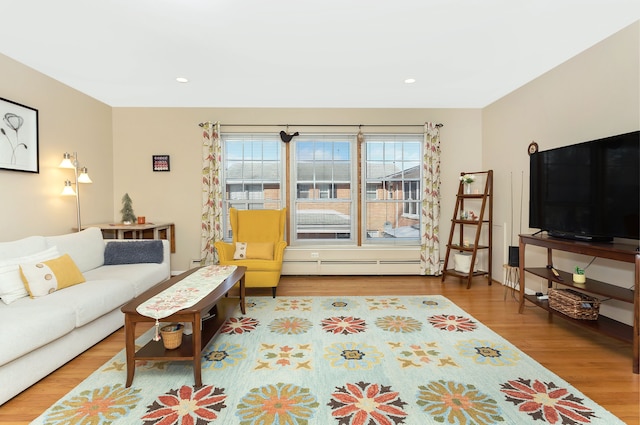 living room with a baseboard radiator and wood-type flooring