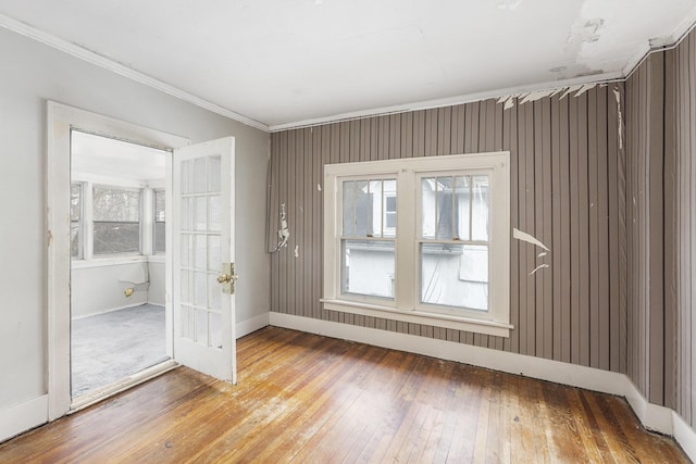 unfurnished room featuring crown molding and wood-type flooring