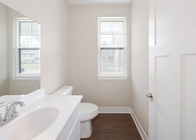 5090 Crandall Rd, Howell, MI 48855 - bathroom with toilet, baseboards, vanity, and wood finished floors