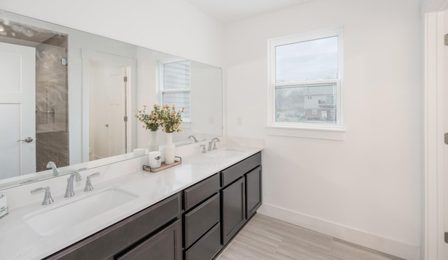 5090 Crandall Rd, Howell, MI 48855 - bathroom with baseboards, double vanity, and a tile shower