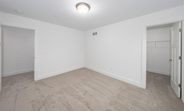 5090 Crandall Rd, Howell, MI 48855 - unfurnished bedroom with carpet, a spacious closet, a closet, and baseboards