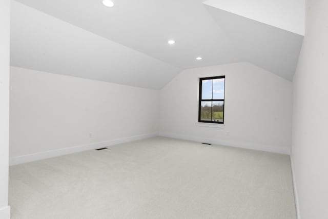 2735 Blue Bird Ln, Highland, MI 48357 - bonus room featuring light carpet, lofted ceiling, recessed lighting, and baseboards