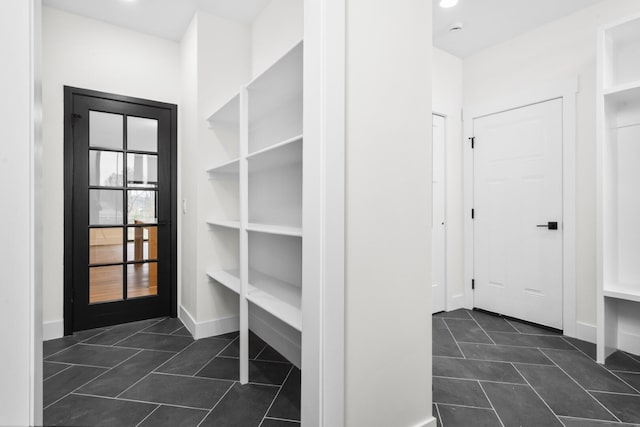 2735 Blue Bird Ln, Highland, MI 48357 - mudroom with tile patterned flooring, baseboards, and built in shelves