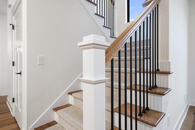 2735 Blue Bird Ln, Highland, MI 48357 - stairway featuring wood finished floors and baseboards
