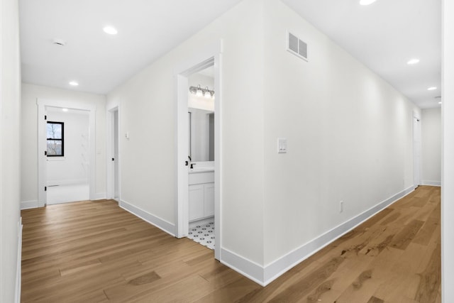 2735 Blue Bird Ln, Highland, MI 48357 - hallway with light wood-style floors, recessed lighting, and baseboards