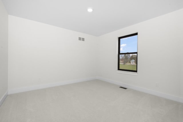 2735 Blue Bird Ln, Highland, MI 48357 - empty room with light colored carpet, baseboards, and recessed lighting