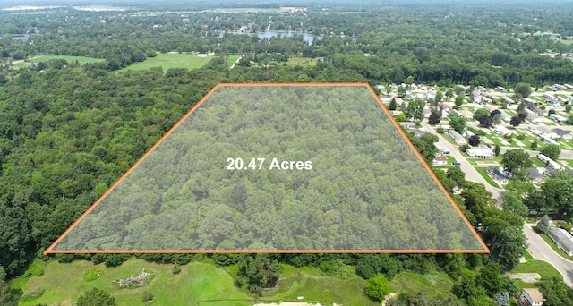 2735 Blue Bird Ln, Highland, MI 48357 - view of property location with a heavily wooded area, property parcel outlined, and a nearby body of water