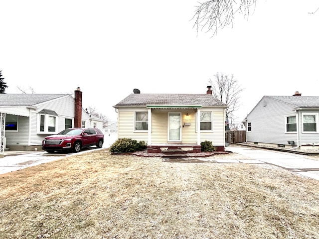 bungalow-style house with a front lawn