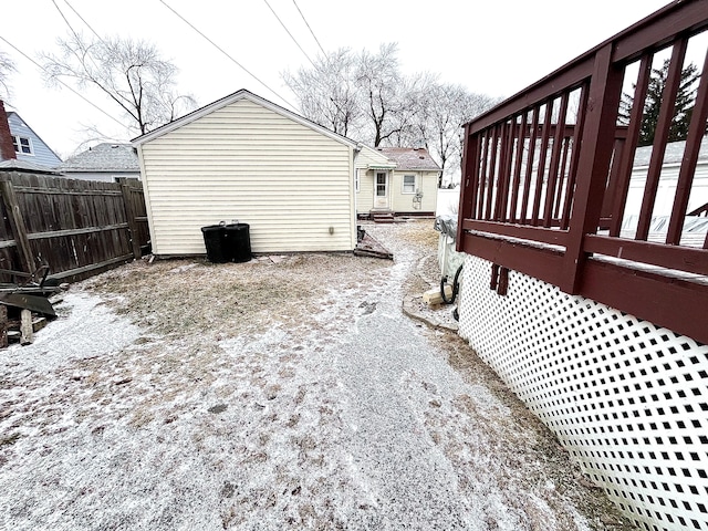 yard layered in snow featuring a deck