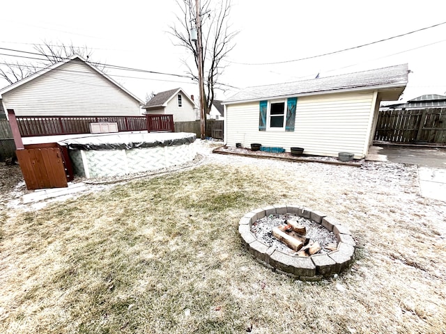 view of yard with a covered pool and an outdoor fire pit