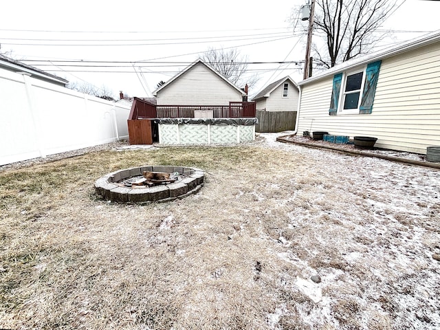 view of yard featuring a covered pool and an outdoor fire pit