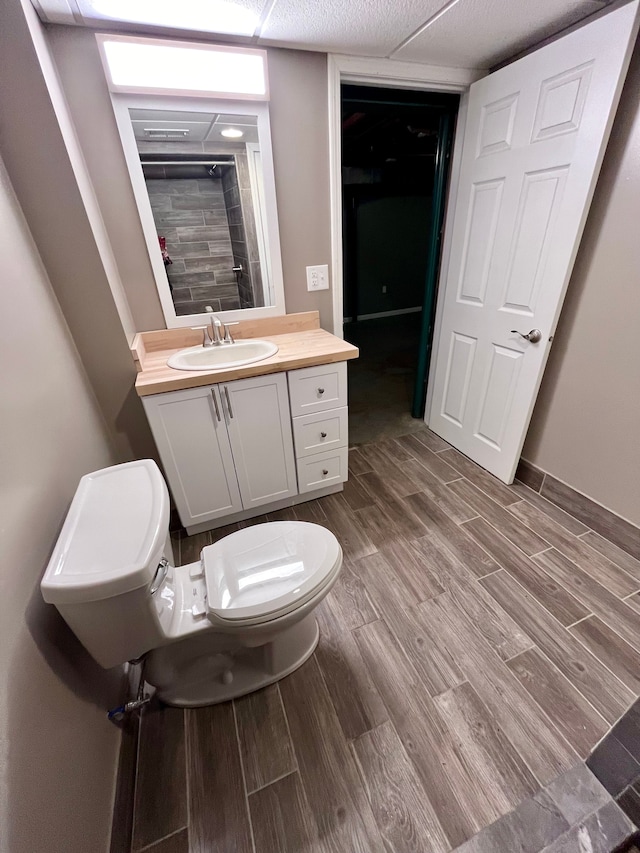 bathroom with vanity, a shower, and toilet