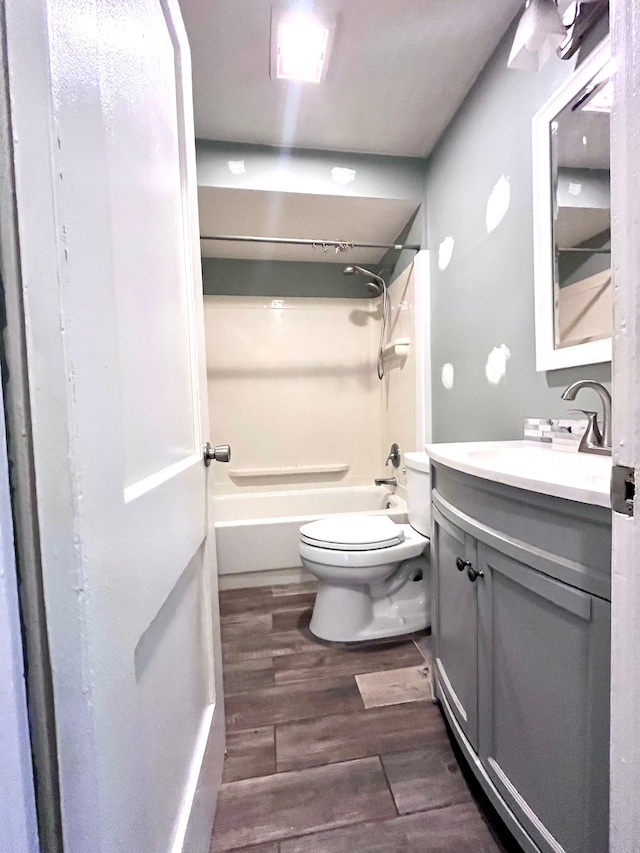 full bathroom with vanity, wood-type flooring, toilet, and shower / bath combination