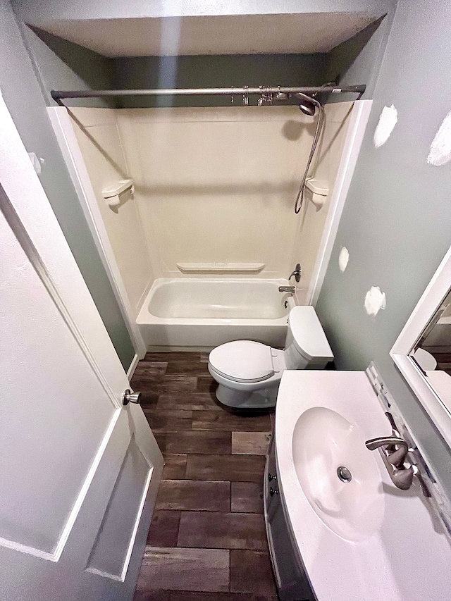 full bathroom featuring vanity, wood-type flooring, bathing tub / shower combination, and toilet