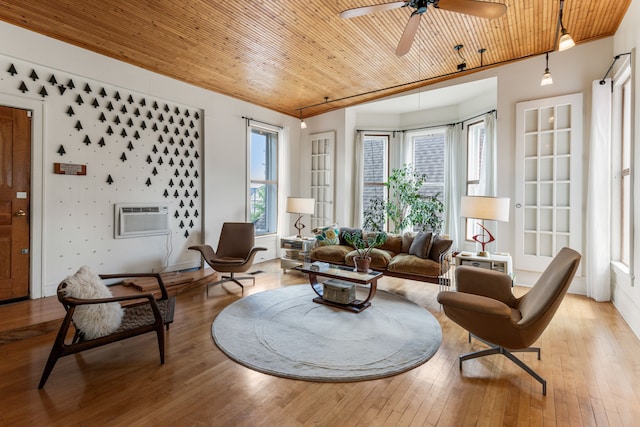 living room featuring a wall mounted air conditioner, wooden ceiling, ceiling fan, and light wood-type flooring