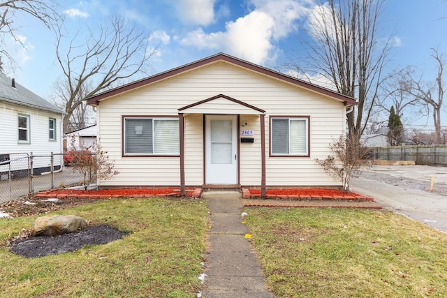 bungalow-style house with a front yard