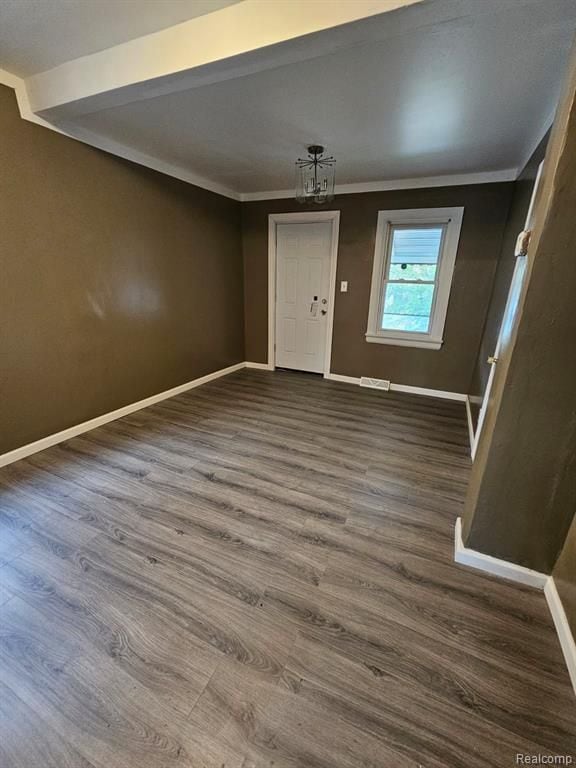 entryway with dark hardwood / wood-style flooring and ornamental molding