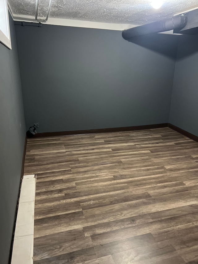 interior space featuring dark wood-type flooring and a textured ceiling