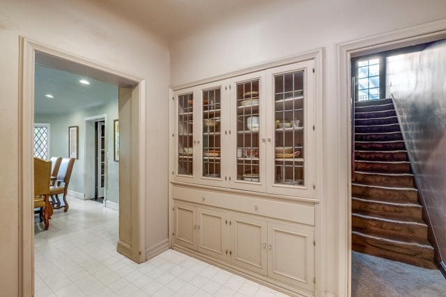 hall featuring baseboards and stairs