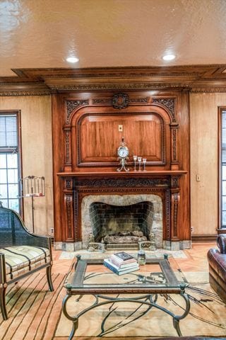 sitting room featuring ornamental molding and a high end fireplace