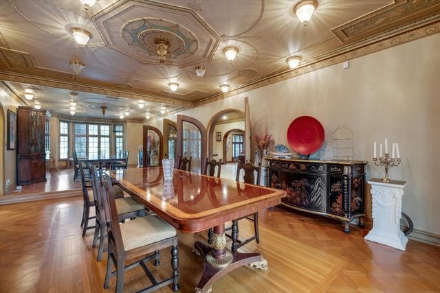 dining area featuring parquet floors and ornamental molding