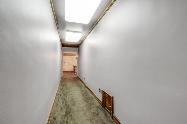 hallway with light colored carpet