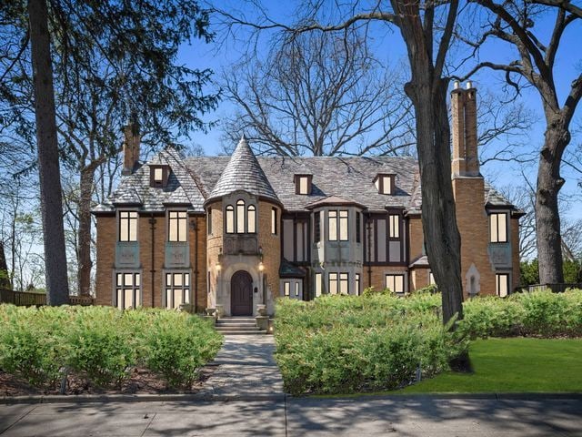 tudor house with brick siding and a chimney