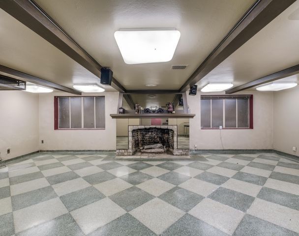 basement with a brick fireplace