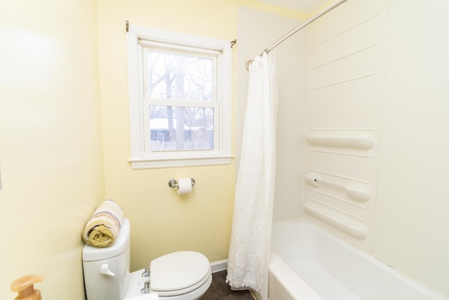 bathroom with shower / tub combo with curtain and toilet