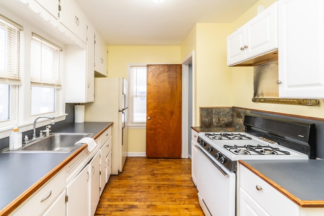 kitchen featuring sink, gas range gas stove, white cabinets, and light wood-type flooring