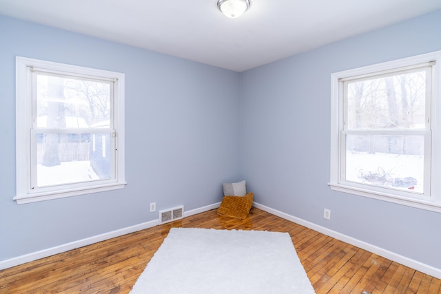 unfurnished room with hardwood / wood-style floors