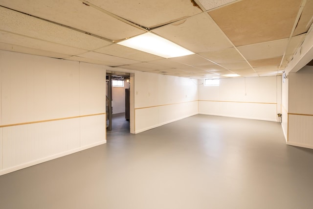 basement with a paneled ceiling