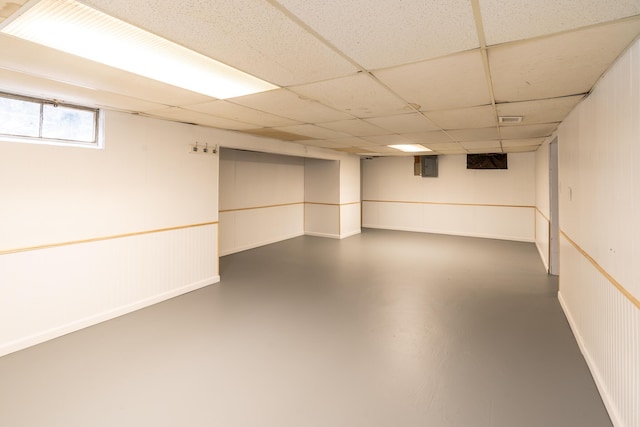 basement with a paneled ceiling