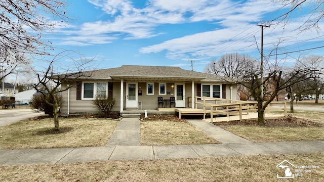 single story home with a front lawn and a porch